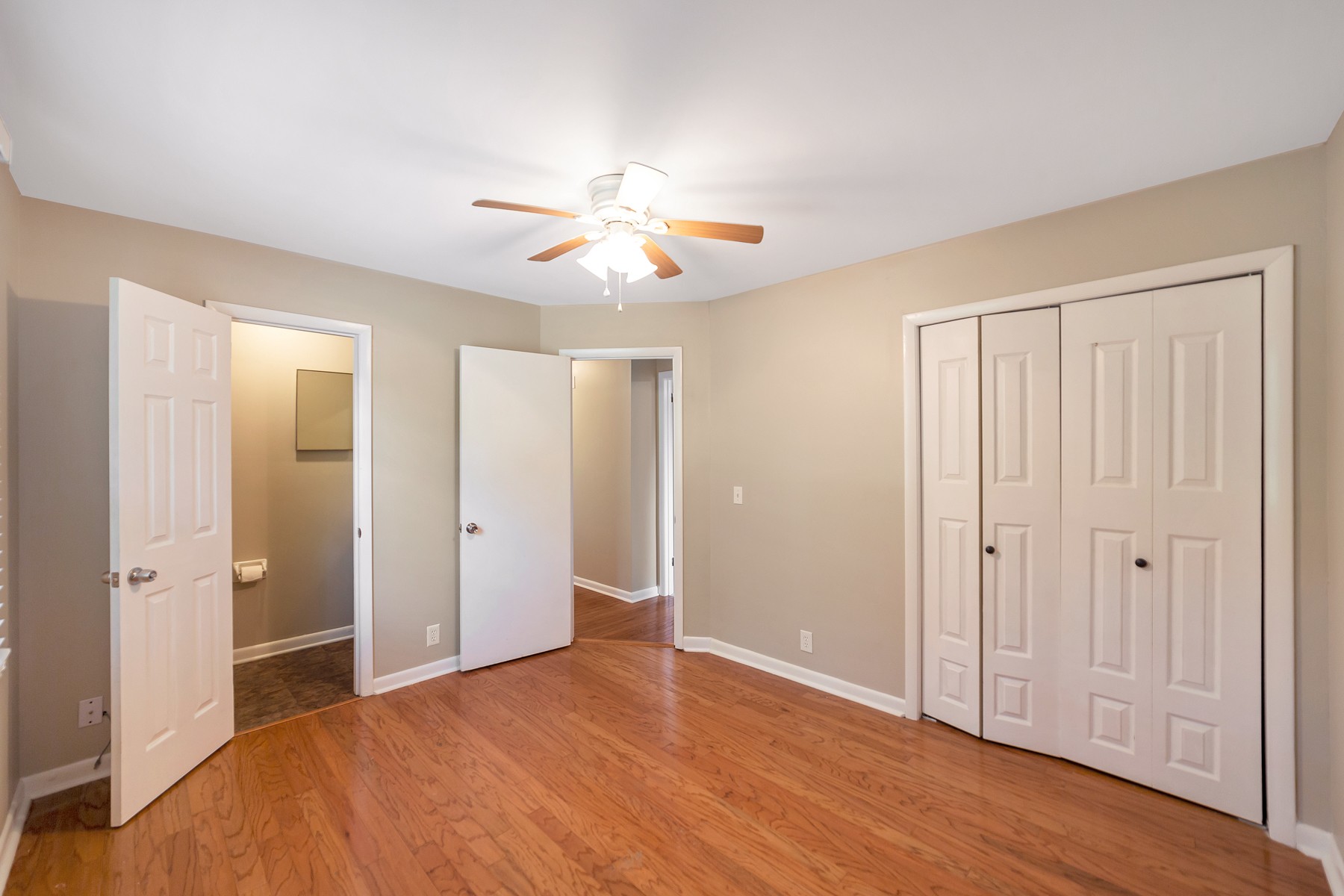 7880 Saundersville Road Mount Juliet, TN 37122 - Photo 7 of 24 an empty room with wooden floor and ceiling fan