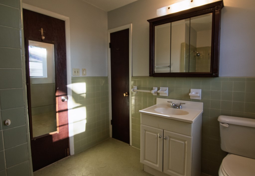 30 North G Street Hamilton, GA 31811 - Photo 13 of 35 a bathroom with a sink a toilet and mirror