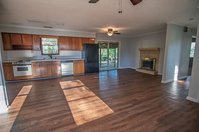 a view of a kitchen with a sink wooden floor and staircase