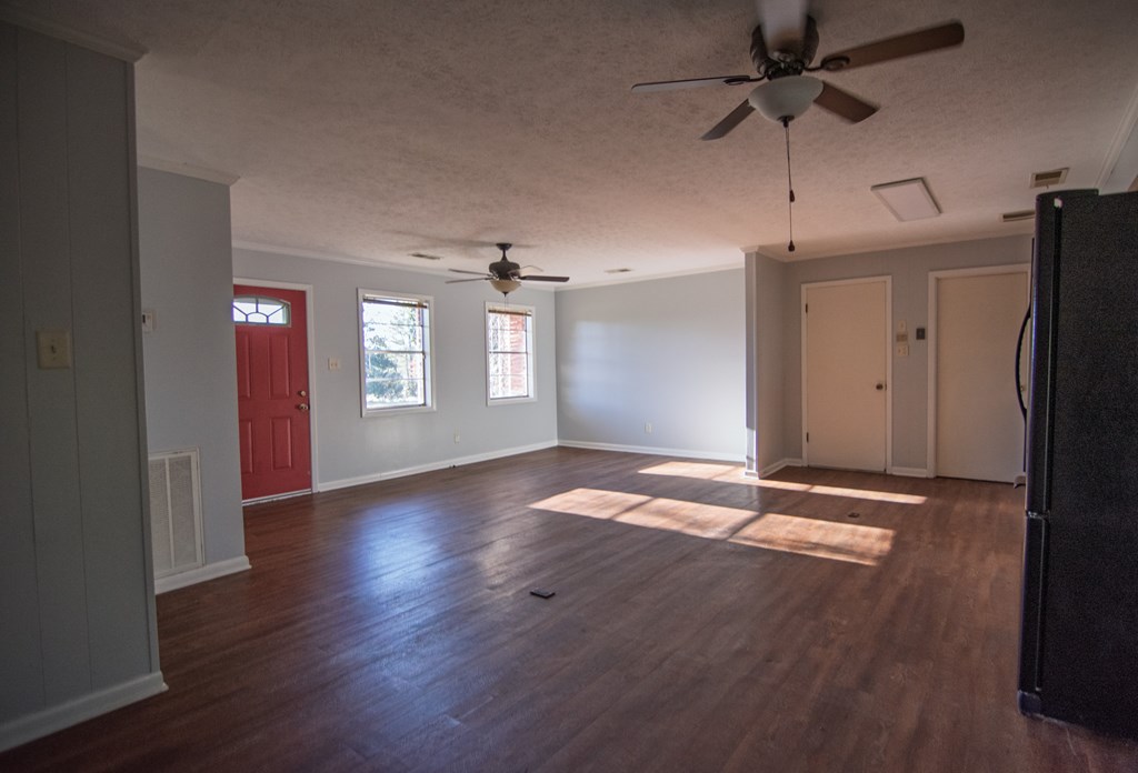 30 North G Street Hamilton, GA 31811 - Photo 10 of 35 a view of an empty room with a window and wooden floor
