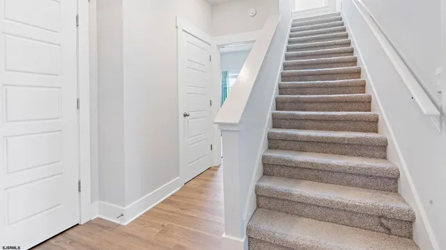a view of staircase with white walls
