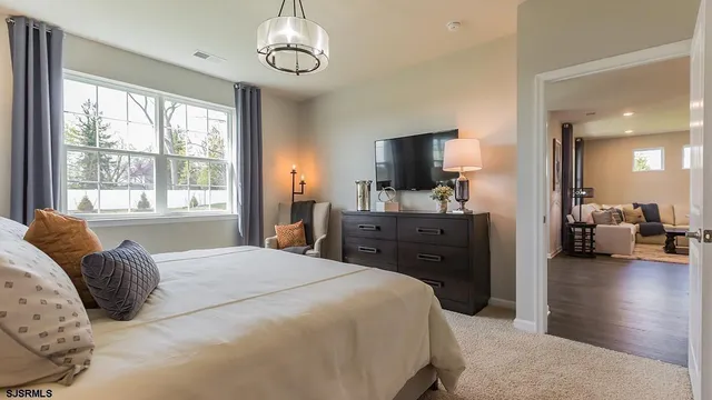a bedroom with a bed and a chandelier