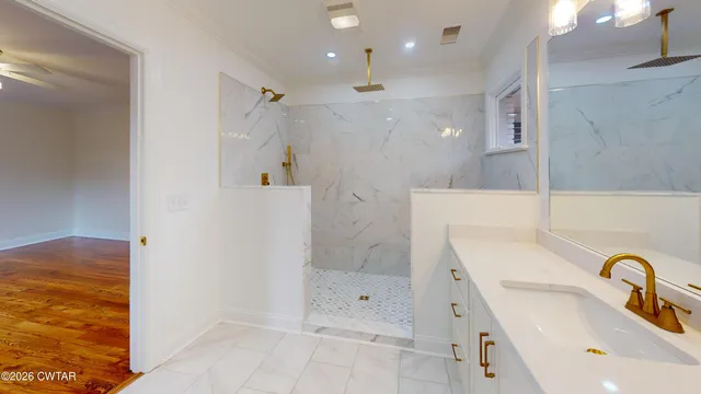 a bathroom with a sink shower and a mirror