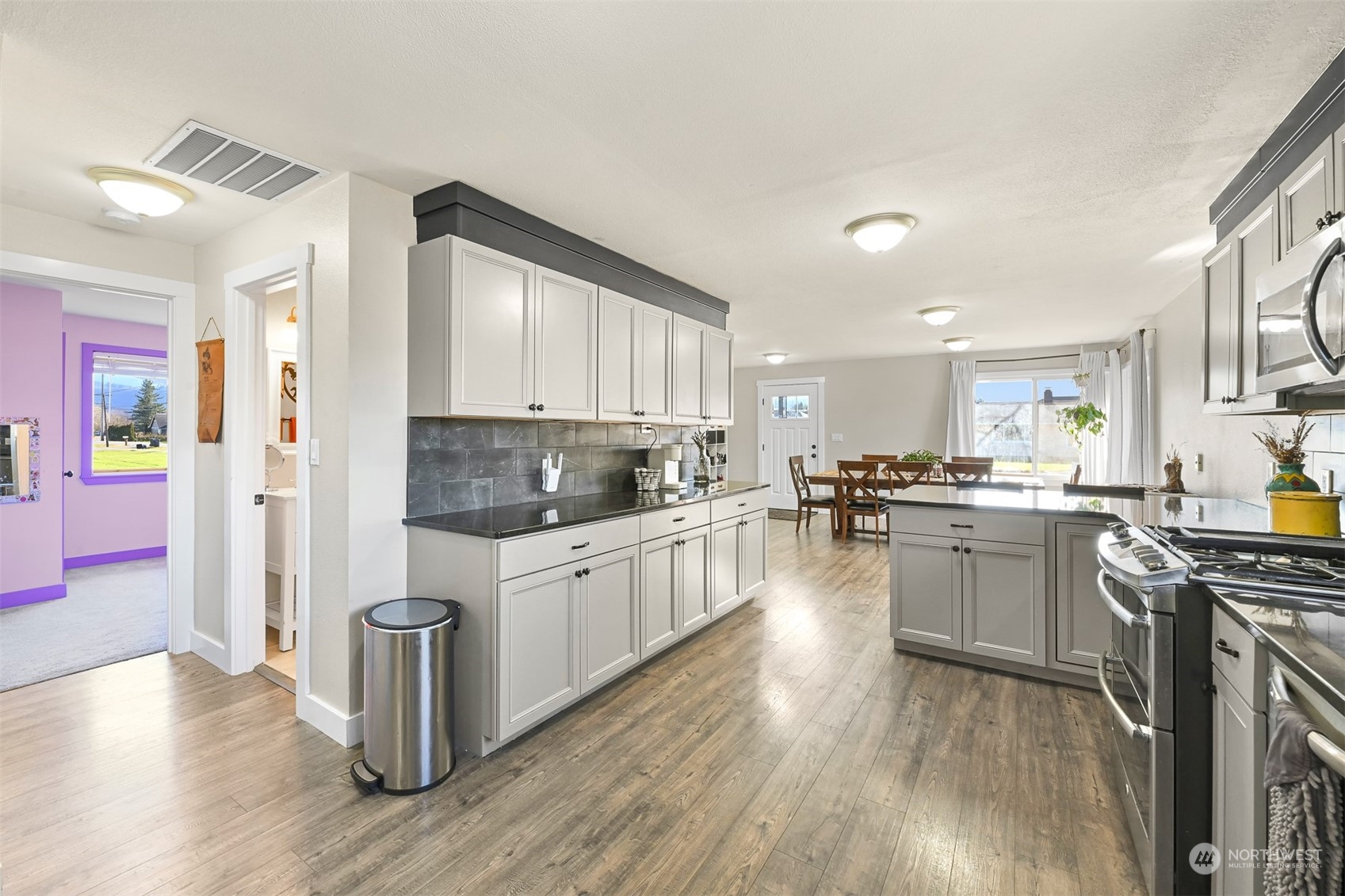 244 Front Street Sumas, WA 98295 - Photo 19 of 40 a kitchen with stainless steel appliances granite countertop wooden floors and white cabinets
