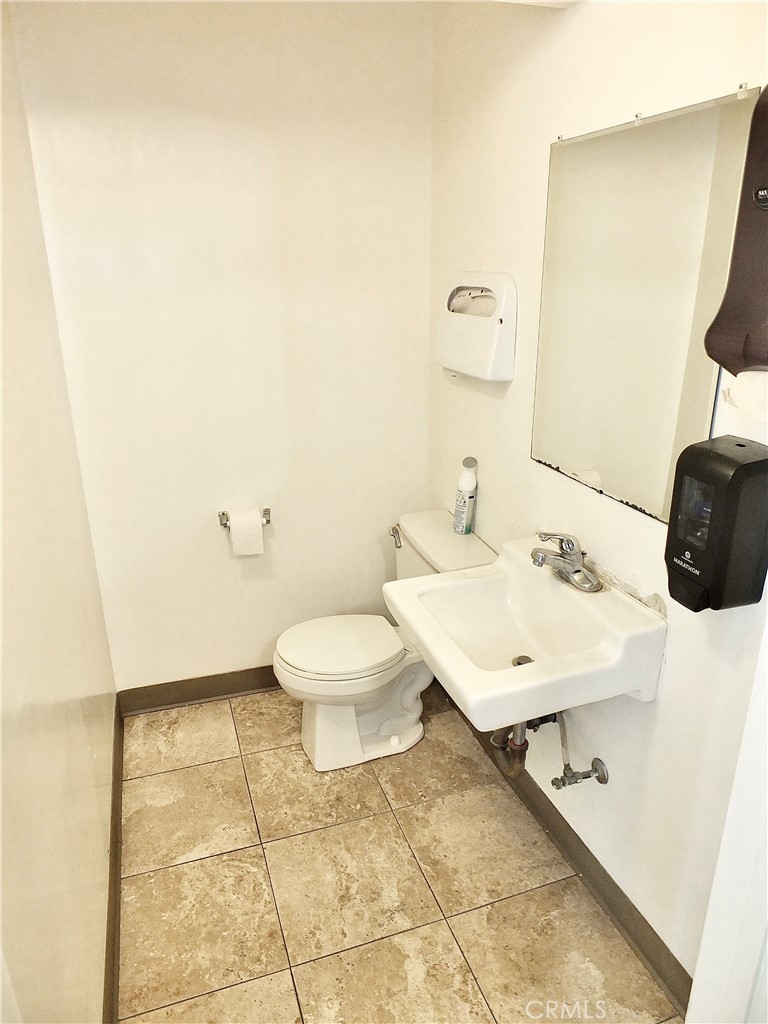 830 Atlantic Avenue Long Beach, CA 90813 - Photo 27 of 75 a bathroom with a sink a toilet and mirror