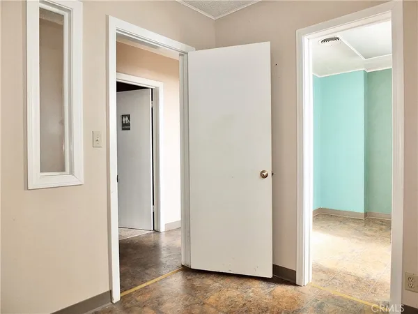 a bathroom with a toilet and a mirror