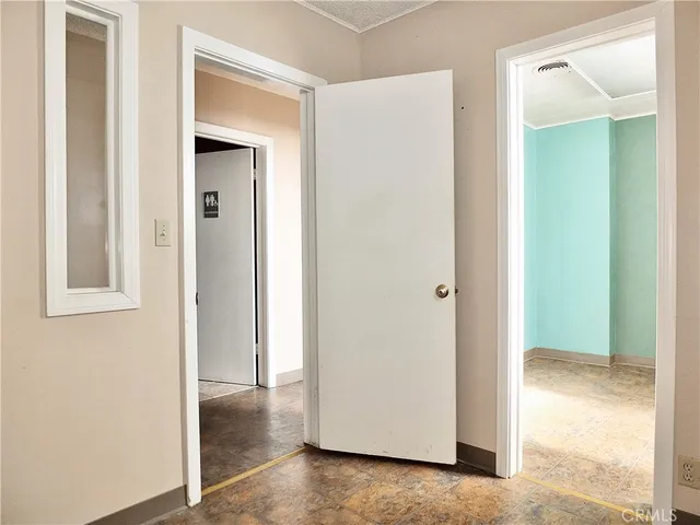 a bathroom with a toilet and a mirror