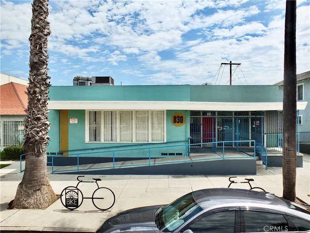 a view of a street with wooden fence