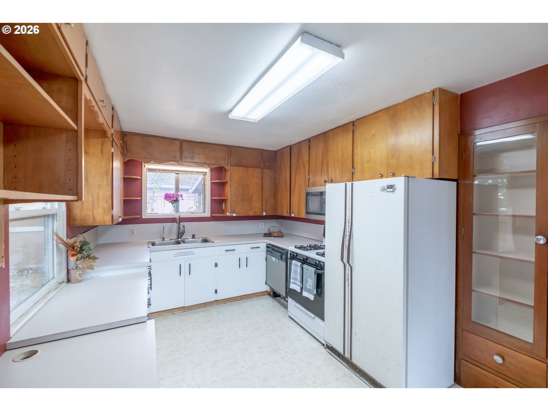 240 South 7th Street Lebanon, OR 97355 - Photo 18 of 27 a kitchen with granite countertop cabinets and refrigerator