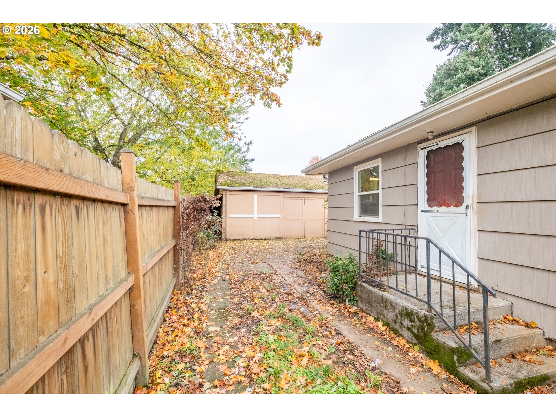240 South 7th Street Lebanon, OR 97355 - Photo 20 of 27 a view of a backyard with wooden fence and large trees