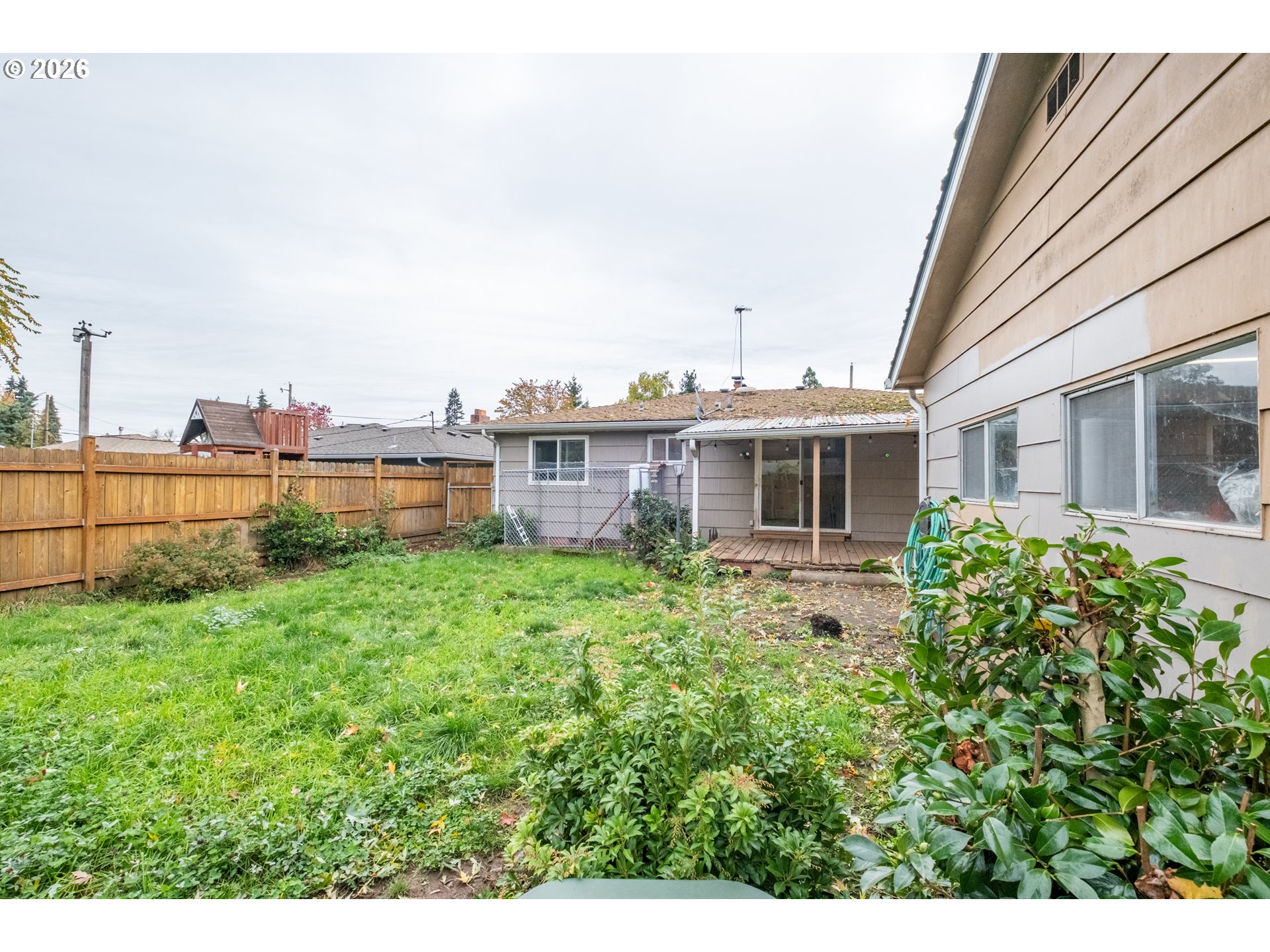 240 South 7th Street Lebanon, OR 97355 - Photo 25 of 27 a view of a house with backyard sitting area and garden
