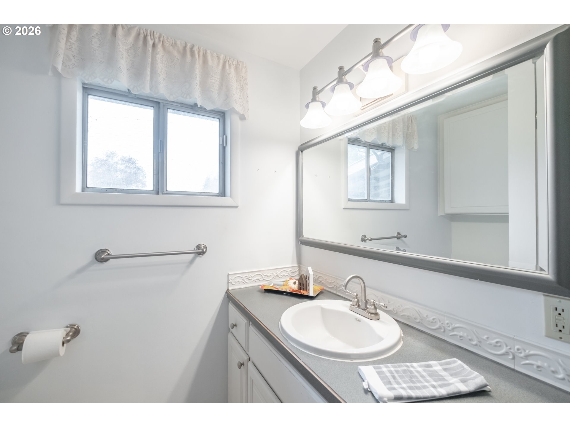 240 South 7th Street Lebanon, OR 97355 - Photo 7 of 27 a bathroom with a sink and a mirror