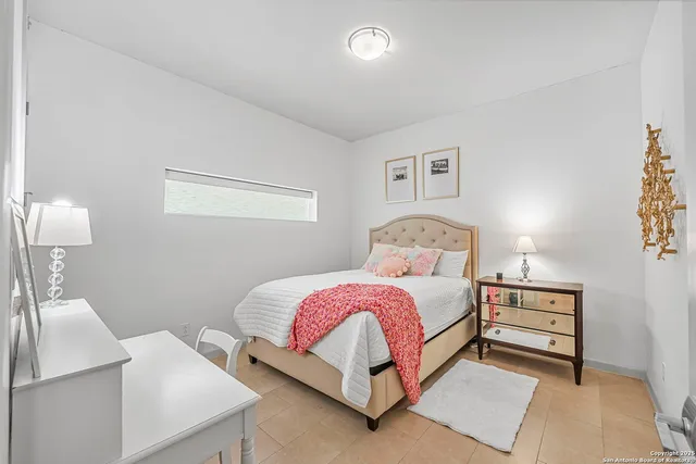 a bedroom with a bed and a lamp