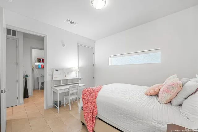 a bedroom with a bed and a cabinets