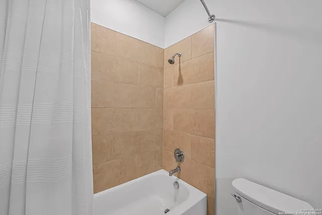 a bathroom with a bathtub and a toilet
