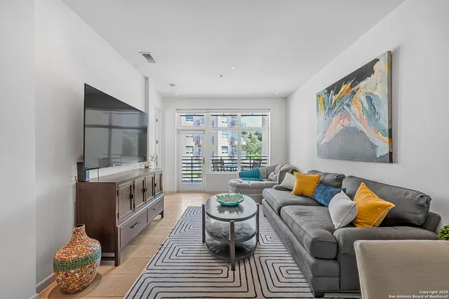 a living room with furniture and a large window