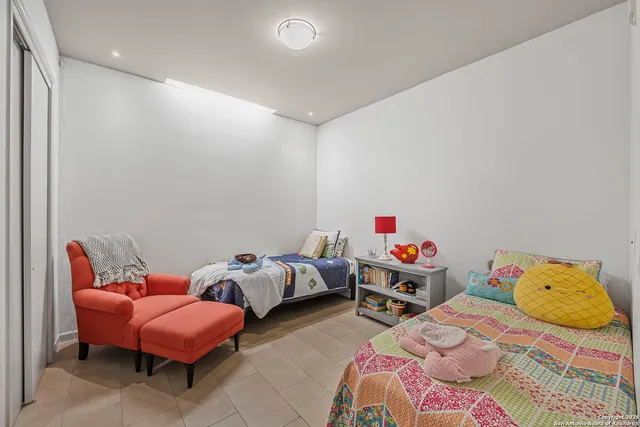 a bedroom with two beds and a couch