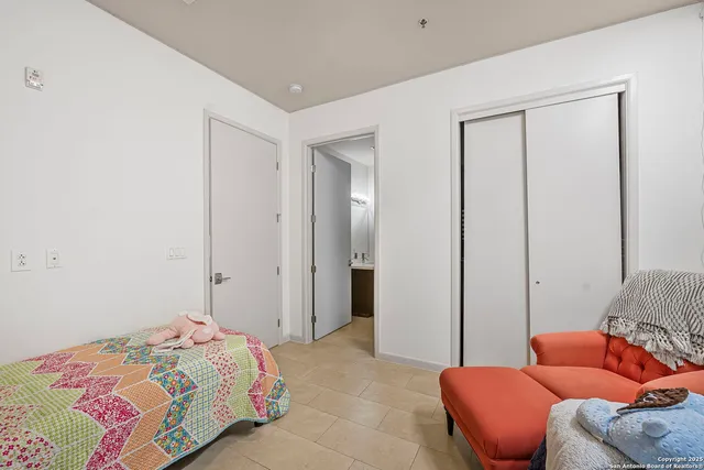 a bedroom with a bed and a couch