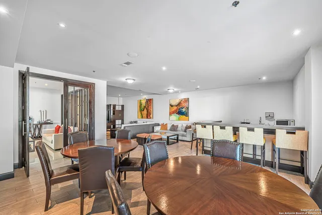 a living room with lots of furniture and view of kitchen