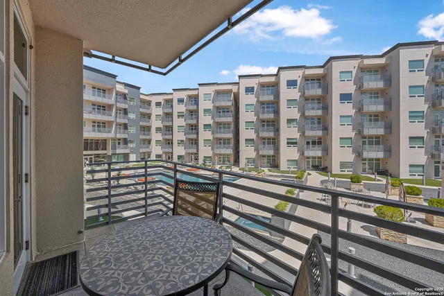 a view of a balcony with a potted plant and stairs