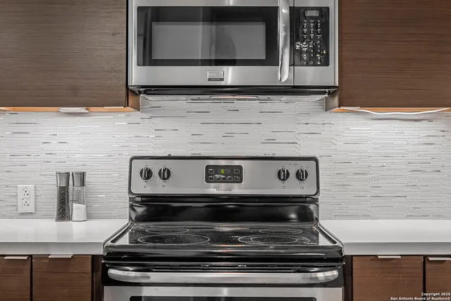 a stove top oven sitting inside of a kitchen