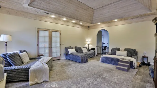 a kitchen with stainless steel appliances kitchen island granite countertop a table chairs sink and cabinets