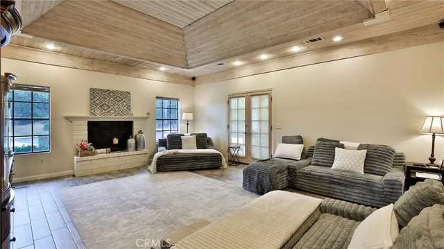 a kitchen with stainless steel appliances kitchen island granite countertop a table chairs sink and cabinets