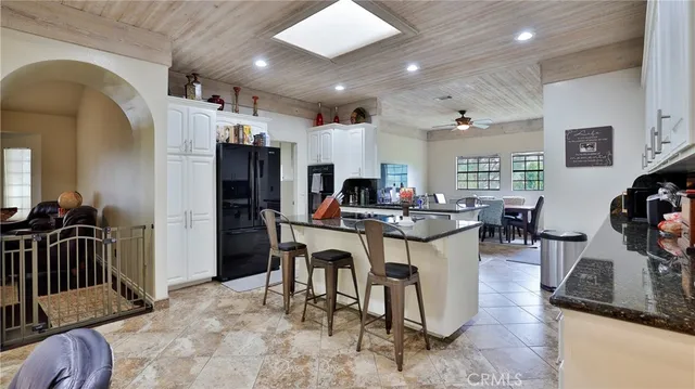 a kitchen with granite countertop a sink and cabinets