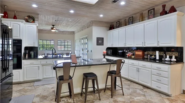 a kitchen with granite countertop white cabinets and a granite counter tops