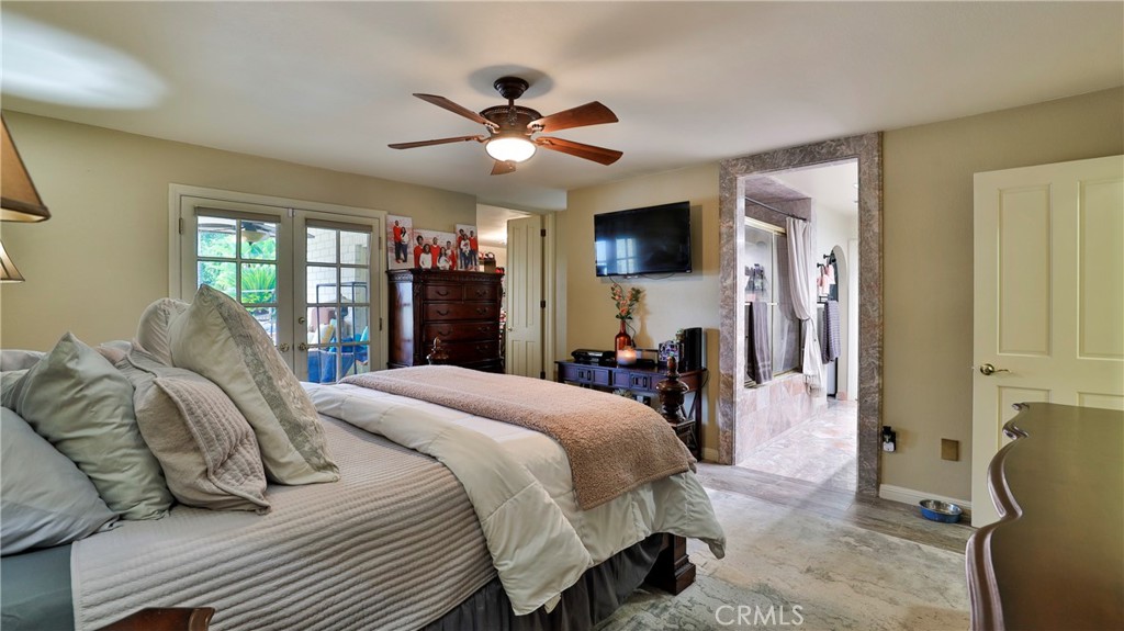 12698 La Solana Drive Redlands, CA 92373 - Photo 26 of 65 a bedroom with a bed and a chandelier