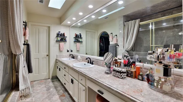 a bedroom with a bed and a dresser in it