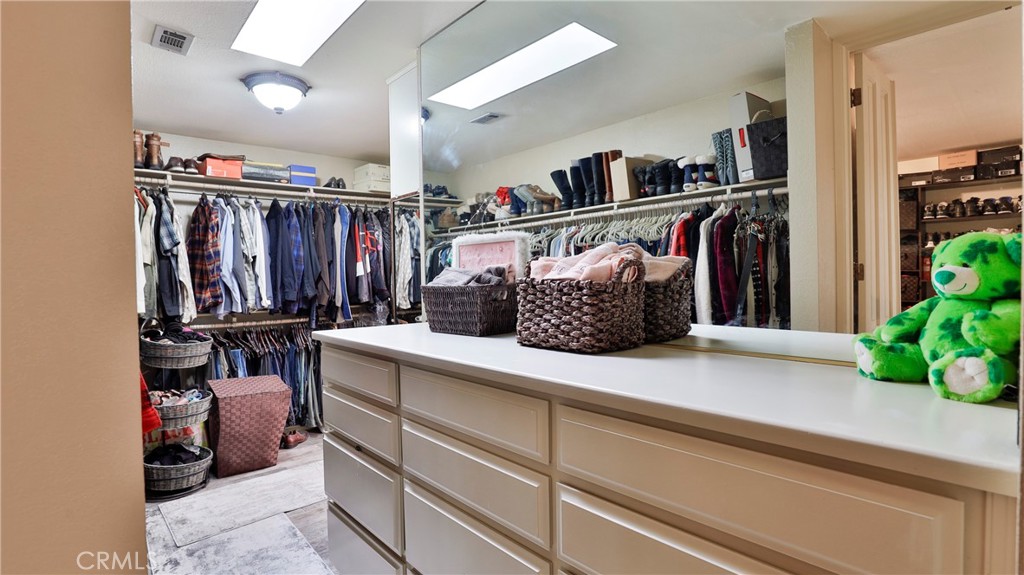 12698 La Solana Drive Redlands, CA 92373 - Photo 29 of 65 a view of walk in closet with clothes and shoes
