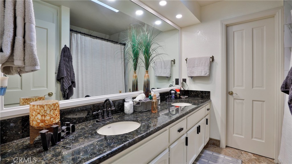 12698 La Solana Drive Redlands, CA 92373 - Photo 32 of 65 a bathroom with double vanity and a mirror