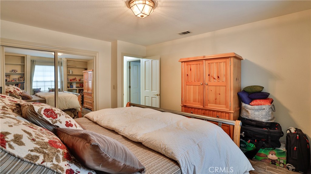 12698 La Solana Drive Redlands, CA 92373 - Photo 34 of 65 a bedroom with a bed and wooden floor
