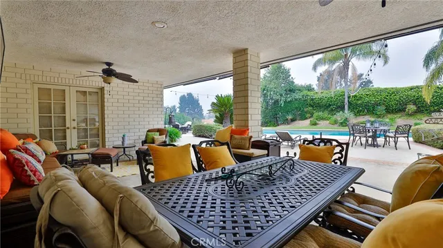 a living room with furniture a flat screen tv and a table