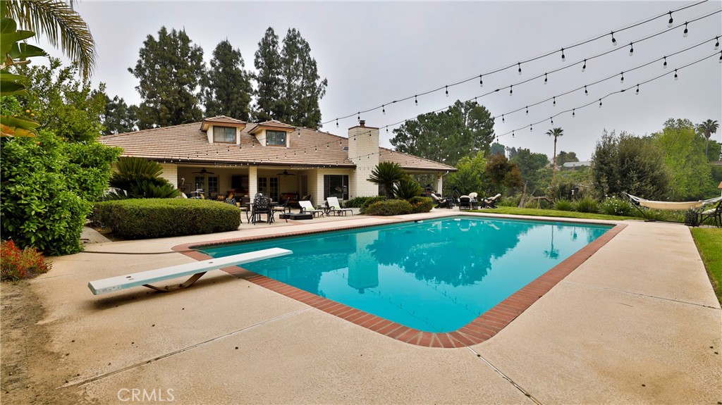 12698 La Solana Drive Redlands, CA 92373 - Photo 45 of 65 a view of a swimming pool and lounge chairs