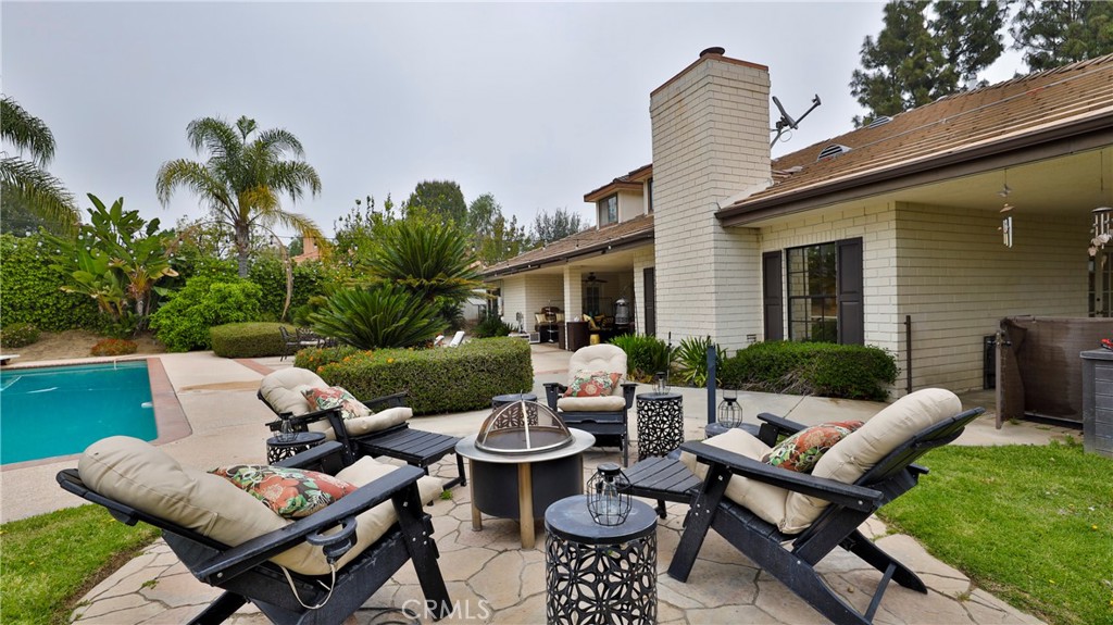 12698 La Solana Drive Redlands, CA 92373 - Photo 52 of 65 a view of a patio with couches table and chairs and potted plants