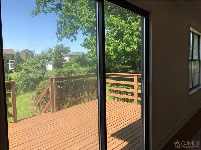 a view of a balcony with floor to ceiling windows with wooden floor