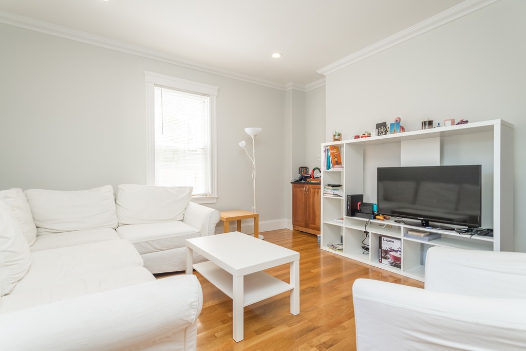 23 Hurd Road, Unit 1 Brookline, MA 02445 - Photo 2 of 12 a living room with furniture and a flat screen tv