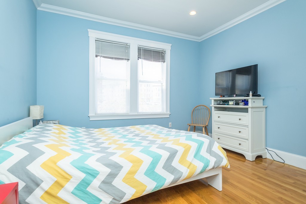 23 Hurd Road, Unit 1 Brookline, MA 02445 - Photo 6 of 12 a bedroom with a bed and a flat screen tv