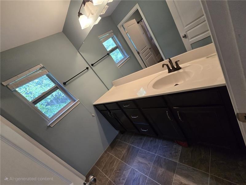 6850 Rocking Horse Lane Cumming, GA 30040 - Photo 19 of 36 a bathroom with a sink and a mirror