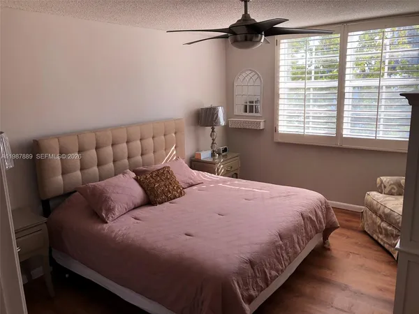 a view of a bedroom with wooden floor
