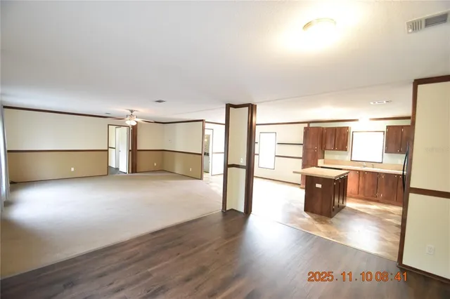 a view of a kitchen with a sink and a refrigerator