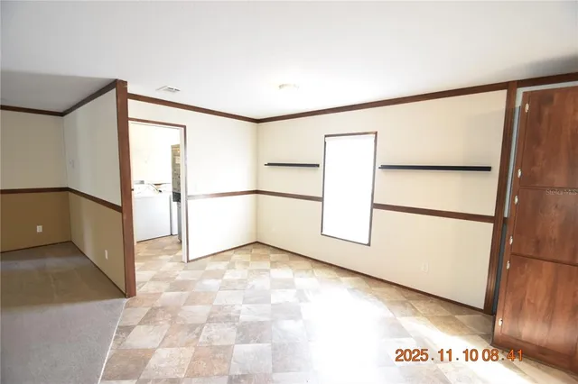 a view of an empty room with a window