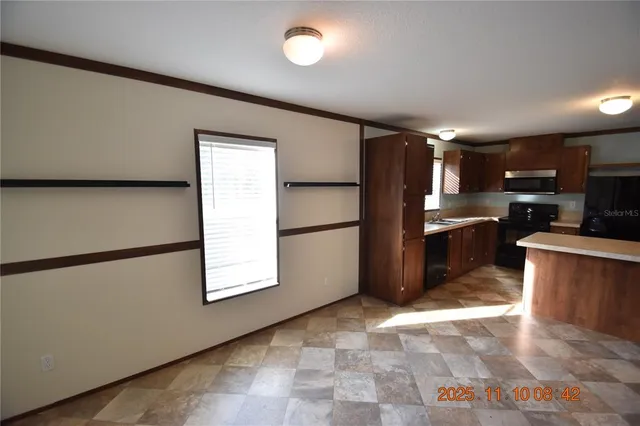 a kitchen with stainless steel appliances granite countertop a refrigerator a stove a sink and a refrigerator