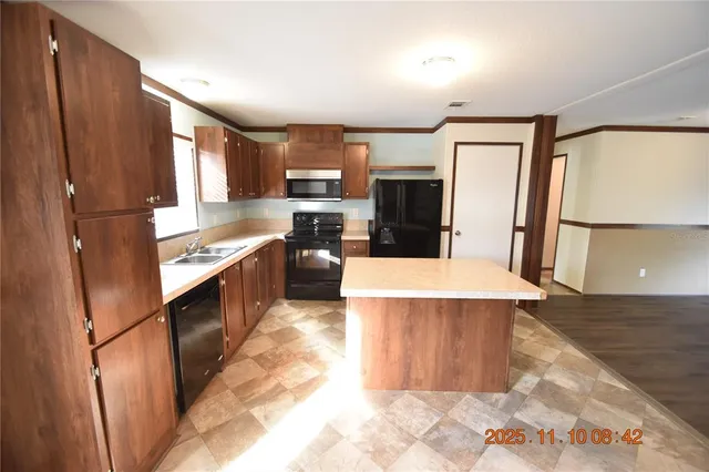 a kitchen with a refrigerator stove and microwave