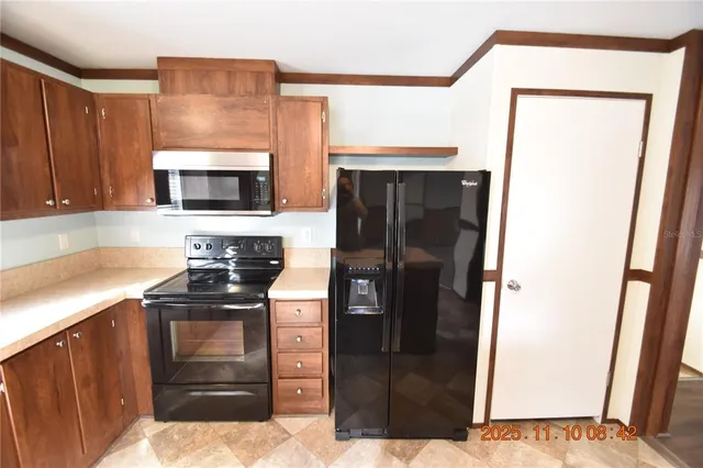 a kitchen with a sink a stove and cabinets