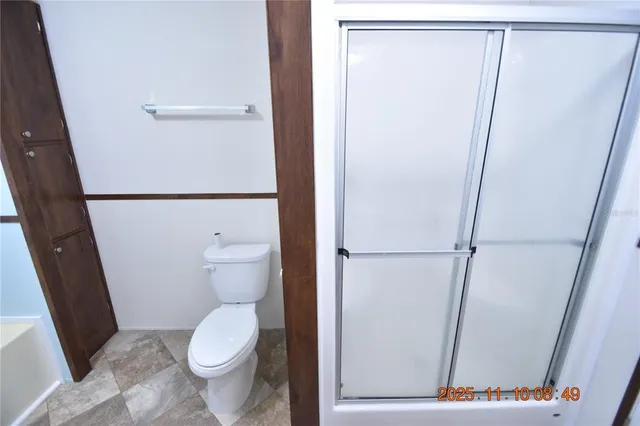 a view of a room with a refrigerator and a window