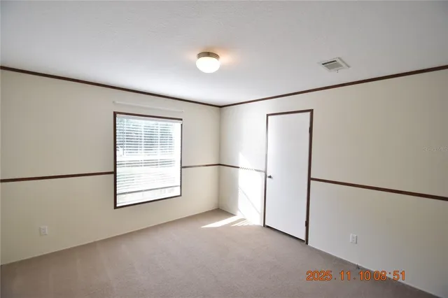 a view of a big room with wooden floor and windows