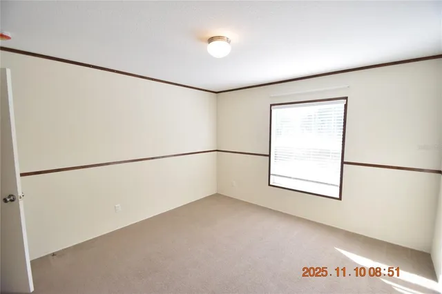 a view of a refrigerator in an empty room
